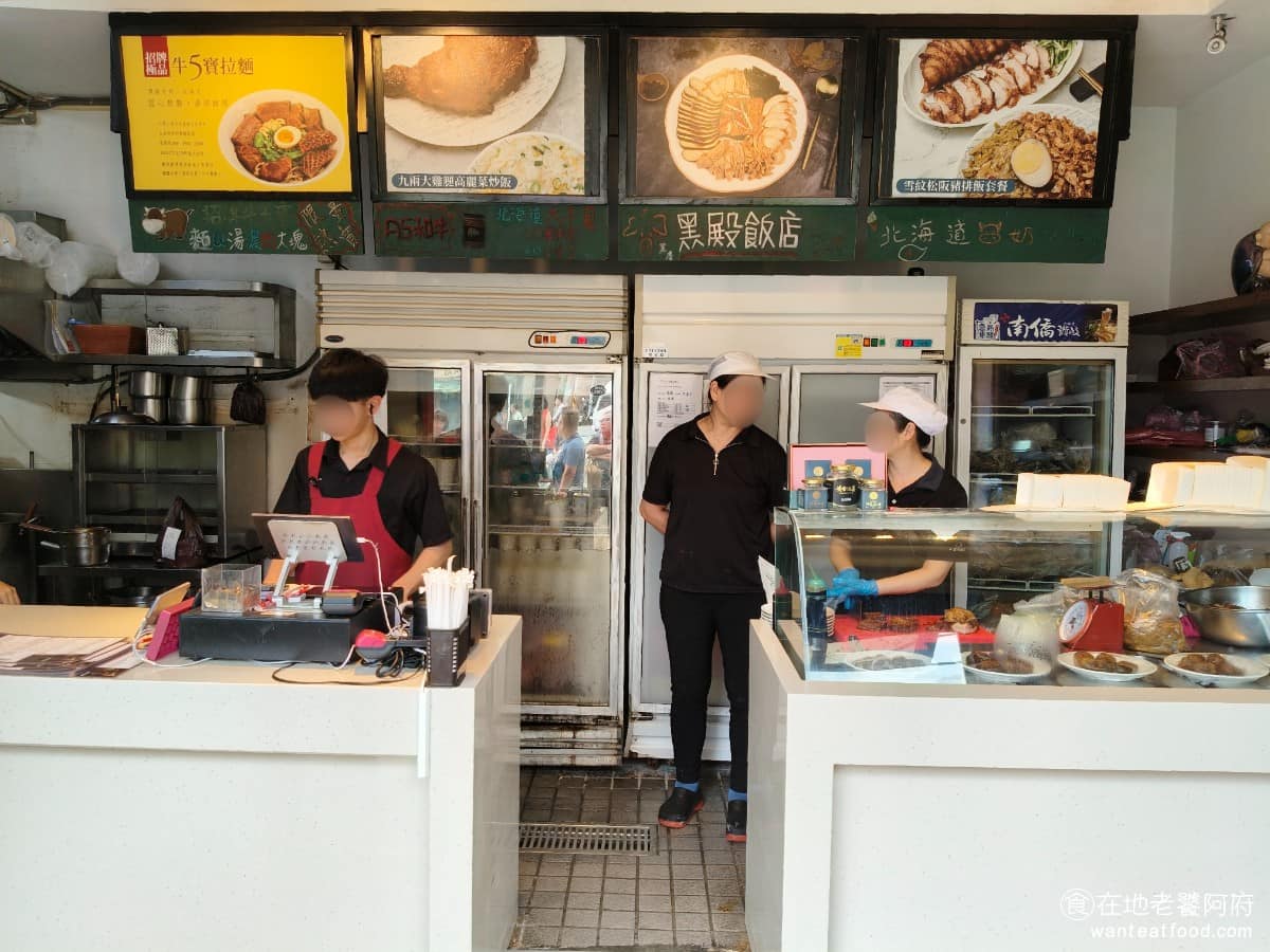 黑殿飯店右岸店 黑殿飯店右岸店菜單 黑殿飯店右岸店推薦 淡水區美食 淡水美食 台灣小吃 排骨飯 炒飯 《黑殿飯店》的創辦人許文苑，是海軍退役的外省老兵，1971 年在淡水往沙崙路邊，用木板搭了個小攤，賣水餃、豬腳和飯類。當時為了防蟲蛀，在木板外塗了黑色柏油，讓整間攤子看起來黑漆漆的，又沒有掛招牌，附近居民就笑稱他為「黑店」，名字就這樣傳開了。 @在地老饕阿府