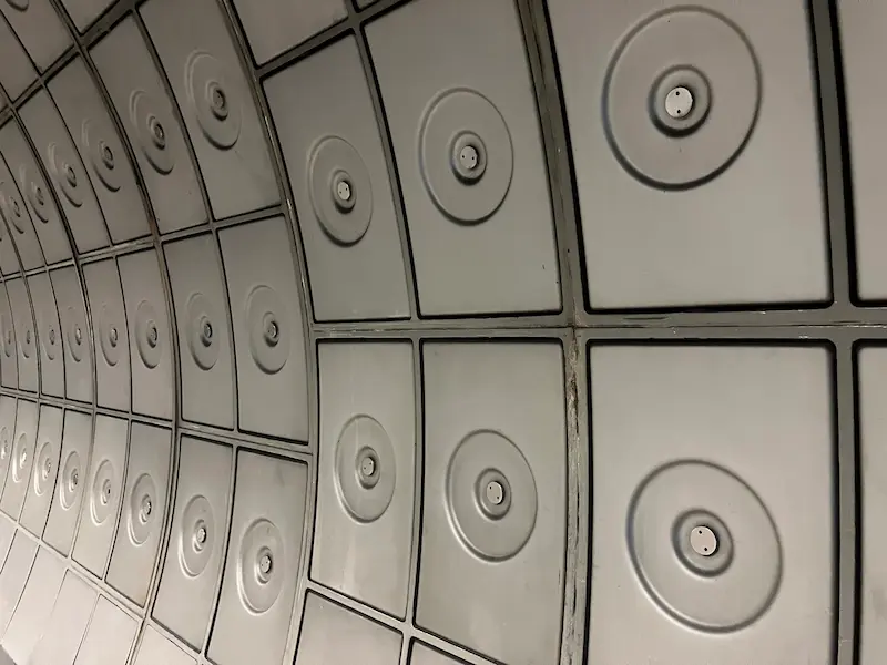 Grey tiles lining the walls of a tunnel on the London Underground