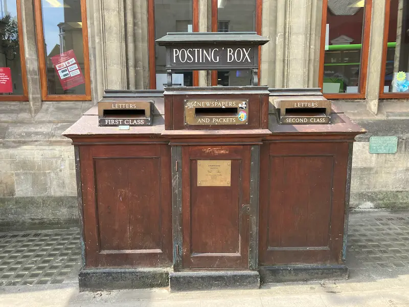 An old wooden postbox outside the Post Office in Oxford, UK