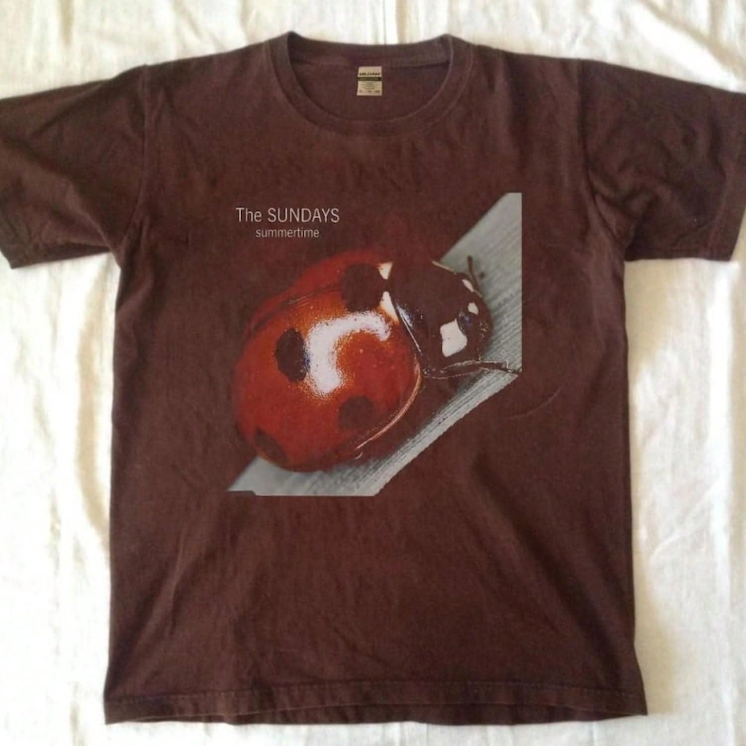 t-shirt features the album art for T &hellip;