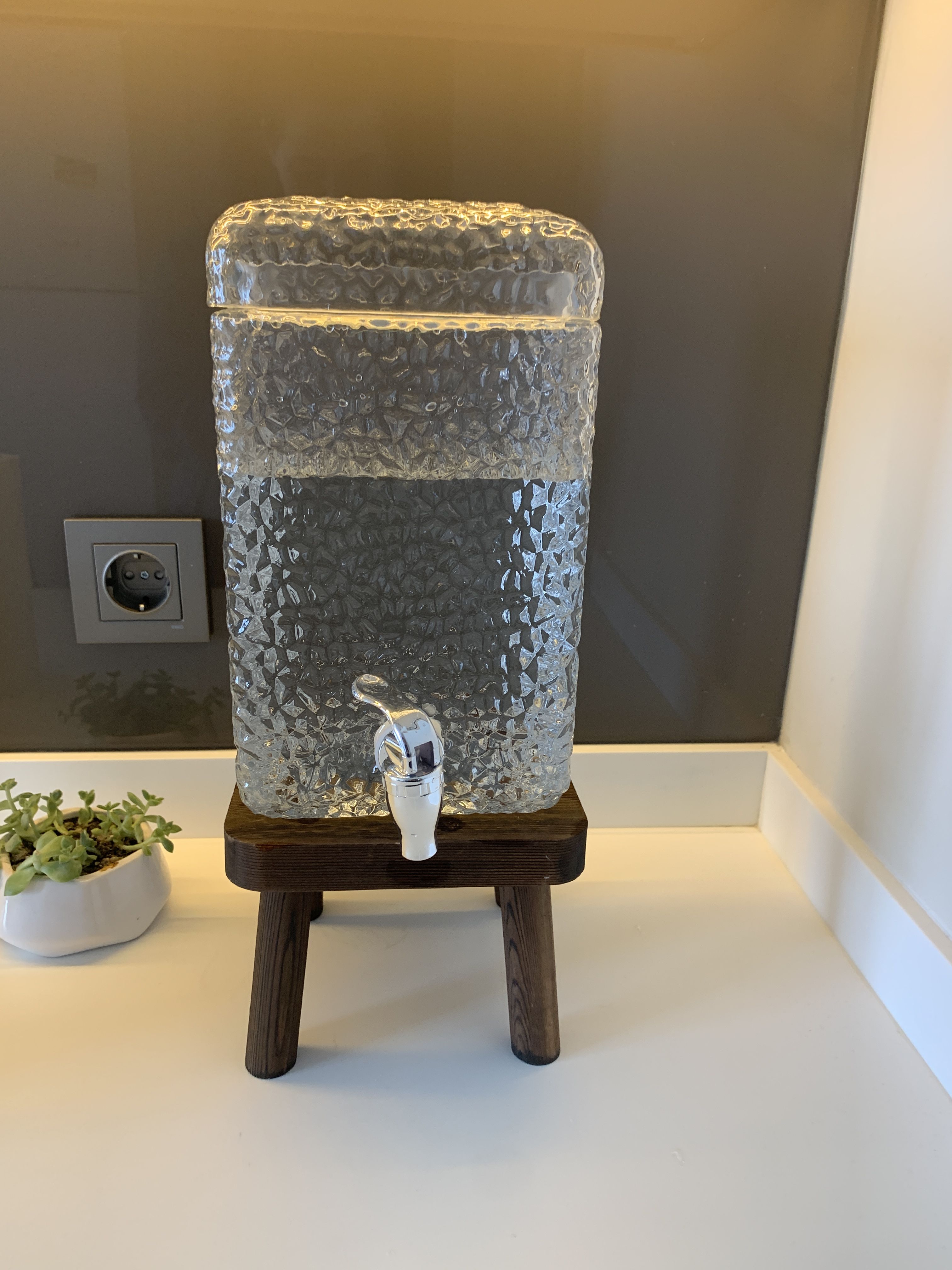 Glass Water Fountain Dispenser on a Wooden Stand