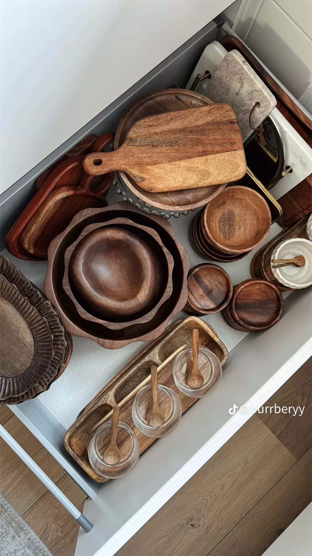 Wooden Dinnerware Set Organized in a Kitchen Drawer
