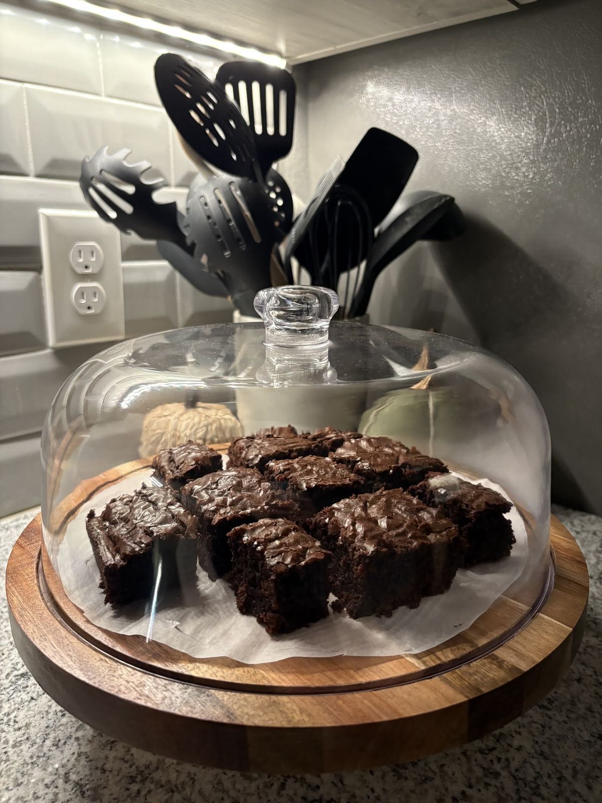 Chocolate Brownies Displayed under a Glass Cake Dome
