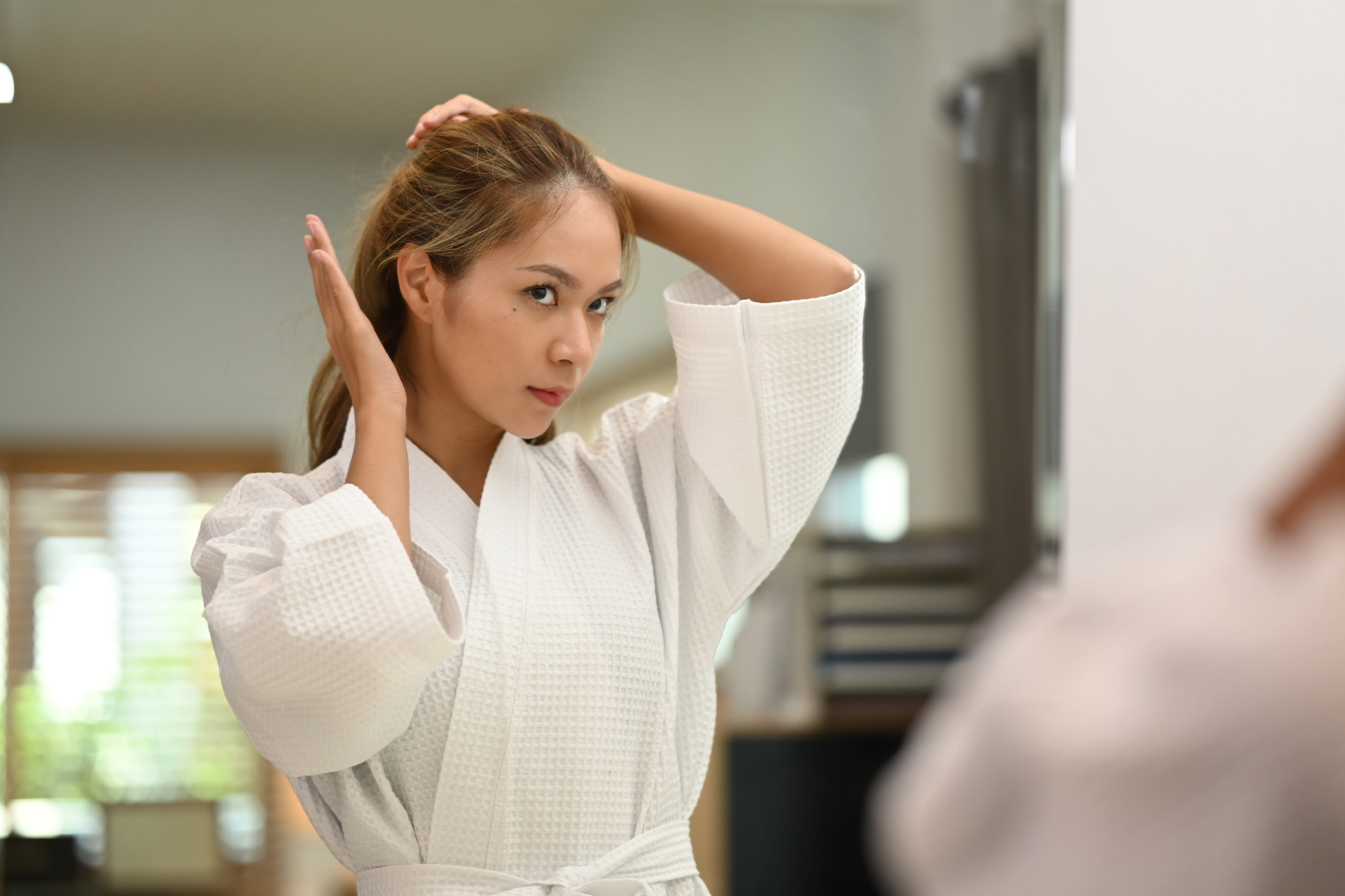 Woman noticing hair changes in her daily routine
