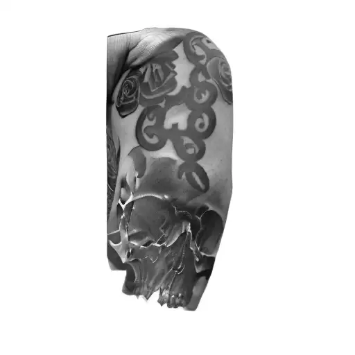 A Man With A Tattoo Of A Skull And Roses