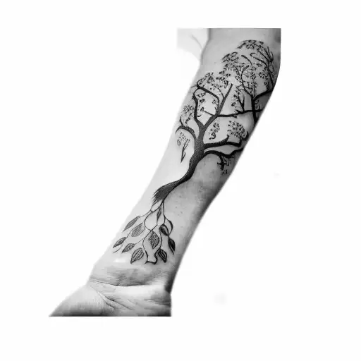 A Tattoo Of A Tree And A Bird