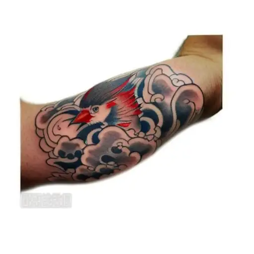 A Man With Japanese Cloud Tattoos On His Arm With Tiny Red Cardinals Mixed In