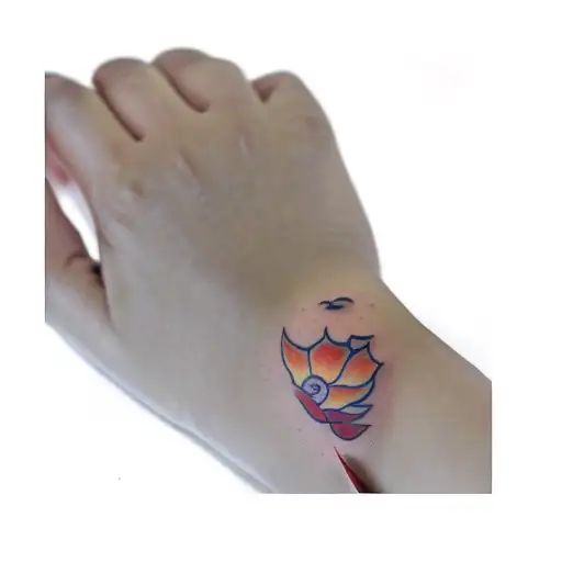 A Sun Tattoo On A Person's Hand