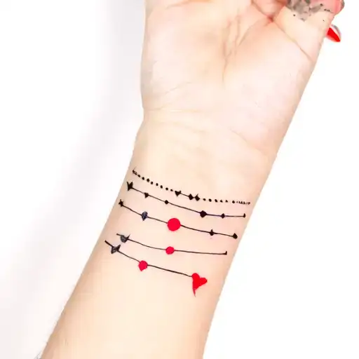 Sleeve Of Many Small Tattoos Cute In Black With Red Details