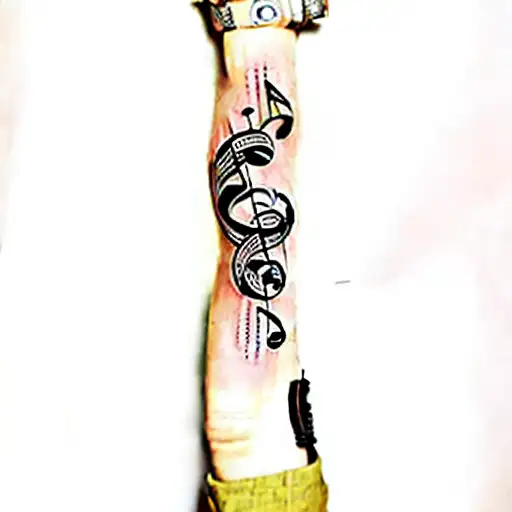 A Person's Arm With Music Notes Tattooed On It