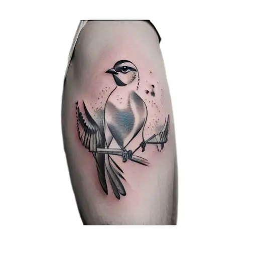 A Tattoo Of A Bird On A Woman's Thigh